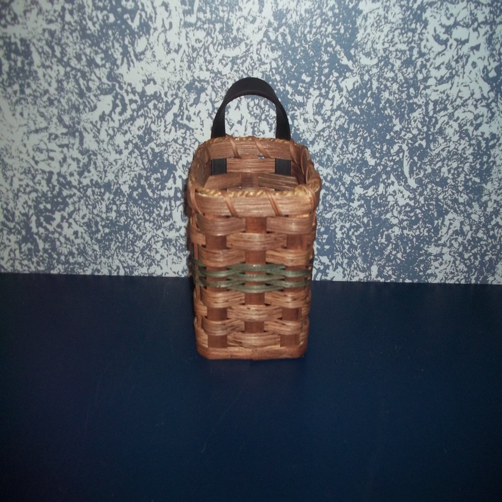 Amish Country Handmade Comb and Brush Holder Basket. Measures 4 1/4" X 4 1/4" X 5 1/2". Amish Handmade Basket Designed to Hold Comb and Brush Set. Add Country Charm to Your Home By Hanging This Basket on the Wall in Your Bathroom. Never Lose Your Com