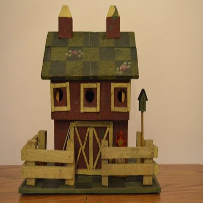 Large Wood Standing Birdhouse Decoration Resembling a Red Barn with a Fence Around the Green Checkered Yard and Pink Roses on the Green Checkered Roof; There Are Three (3) Access Holes for Birds and Large Nesting Area Inside of the Barn. Measurements