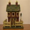 Large Wood Standing Birdhouse Decoration Resembling a Red Barn with a Fence Around the Green Checkered Yard and Pink Roses on the Green Checkered Roof; There Are Three (3) Access Holes for Birds and Large Nesting Area Inside of the Barn. Measurements view 1