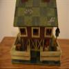 Large Wood Standing Birdhouse Decoration Resembling a Red Barn with a Fence Around the Green Checkered Yard and Pink Roses on the Green Checkered Roof; There Are Three (3) Access Holes for Birds and Large Nesting Area Inside of the Barn. Measurements view 4