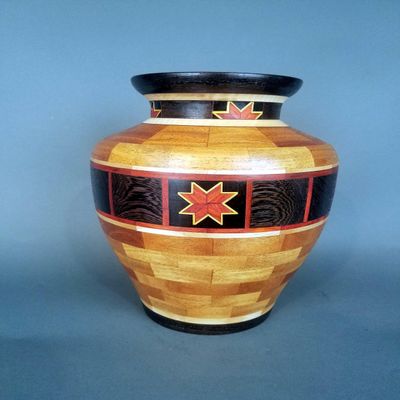 Large Display Vase With A Beautiful Star Design Made From Many Pieces of Hardwood From All Over The World.