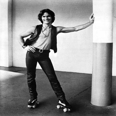 Patrick Swayze wearing roller skates Photo Print (8 x 10)