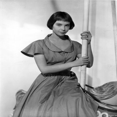 Leslie Caron posed with a Pole in Long Dress Photo Print (8 x 10)