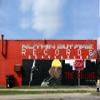 Painted wall sign of a records store with stop sign and rapper images Poster Print (18 x 24) view 1