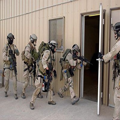 Pararescuemen enter a building to retrive wounded hostages Poster Print by Stocktrek Images (17 x 11)