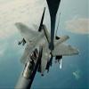 An F-15E Strike Eagle receives fuel from a KC-135R Stratotanker Poster Print by Stocktrek Images (17 x 11) view 1