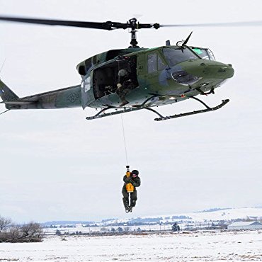A student is hoisted into a UH-1N Iroquois during a training exercise Poster Print by Stocktrek Images (22 x 34)