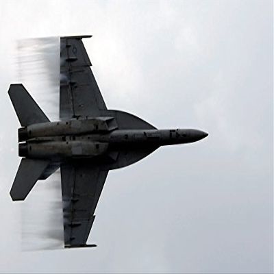 An FA-18F Super Hornet speeds up for a supersonic fly-by Poster Print by Stocktrek Images (17 x 11)