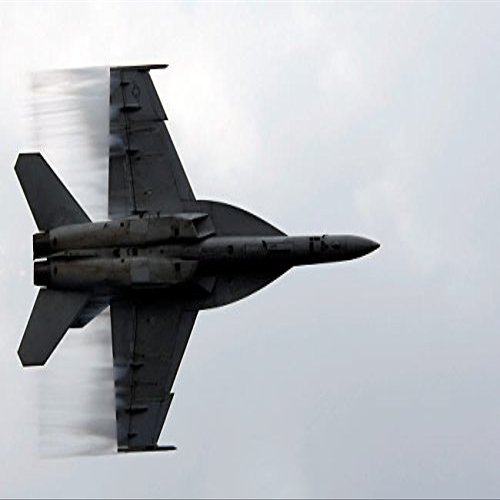 An FA-18F Super Hornet speeds up for a supersonic fly-by Poster Print by Stocktrek Images (17 x 11)