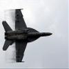 An FA-18F Super Hornet speeds up for a supersonic fly-by Poster Print by Stocktrek Images (17 x 11) view 1