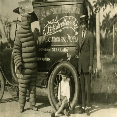 Italian delivery van for candies chocolates gum and other sweets along with Bibendum the early version of the Michelin Man Poster Print by unknown (18 x 24)