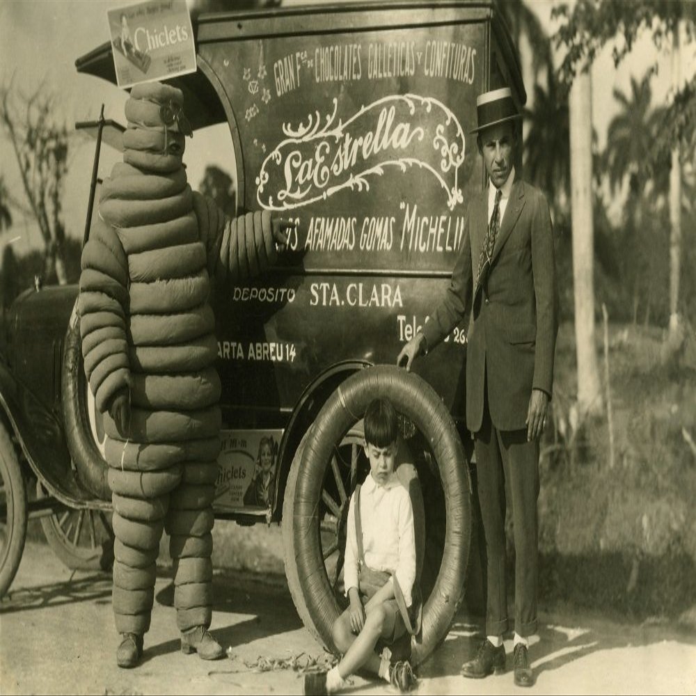 Italian delivery van for candies chocolates gum and other sweets along with Bibendum the early version of the Michelin Man Poster Print by unknown (18 x 24)