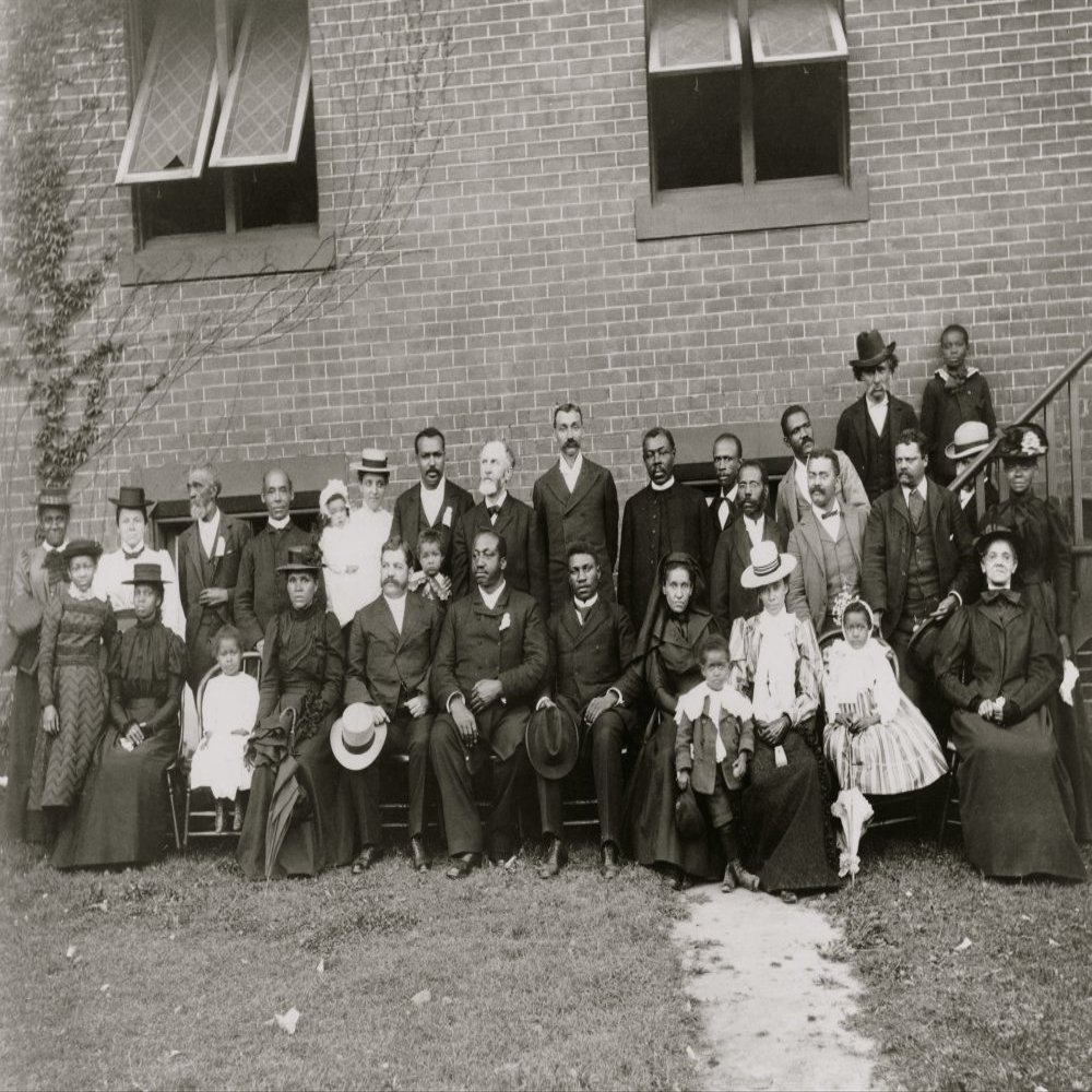 Members of the First Congregational Church Atlanta Georgia posed outside the brick church 30 people including men women and children The Reverend Henry Hugh Proctor is standing seventh from left Poste
