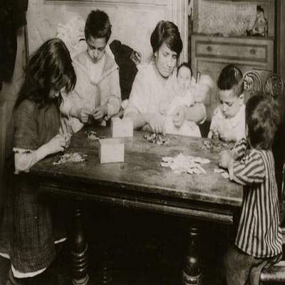 Civarro family 2106 Second Avenue second floor back working on patriotic flag pins They get 3 cents a gross for inserting pin and putting onto card Mrs Civarro with her three-months-old baby in her ar