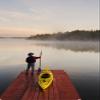 Posterazzi Man Standing Poster Print by Kayak On Dock In Northwestern Lake Of The Woods Ontario Canada, (12 x 18) view 1