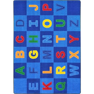 Joy Carpets Kid Essentials Patchwork Letters 5'4" x 7'8" Area Rug in Color Multi