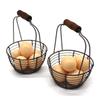 CVHOMEDECO. Metal Wire Mini Egg Baskets Rust Gathering Baskets with Wooden Handle Country Vintage Style Storage Baskets. Set of 2 view 2