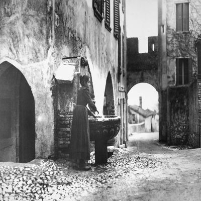 Posterazzi DPI12327863LARGE Woman Washing Hands in Fountain Photo Print, 36 x 26, Multi