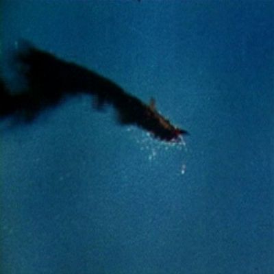 Home Comforts A burning Japanese plane over Sand Island, Midway Islands, 4 June 1942.-20 Inch By 30 Inch Laminated Poster With Bright Colors And Vivid Imagery-Fits Perfectly In Many Attractive Frames