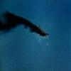 Home Comforts A burning Japanese plane over Sand Island, Midway Islands, 4 June 1942.-20 Inch By 30 Inch Laminated Poster With Bright Colors And Vivid Imagery-Fits Perfectly In Many Attractive Frames view 1