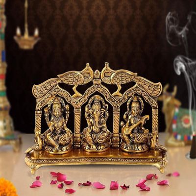 AONA Ganesha Lakshmi and Saraswati Idol Sculpture Seated On Peacock Throne Golden Height 5.5 Inches Width 11.0 Inches
