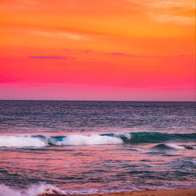 Iconic Arts Breathtaking Orange Sky Over Breaking Wave Laminated Poster 24x36