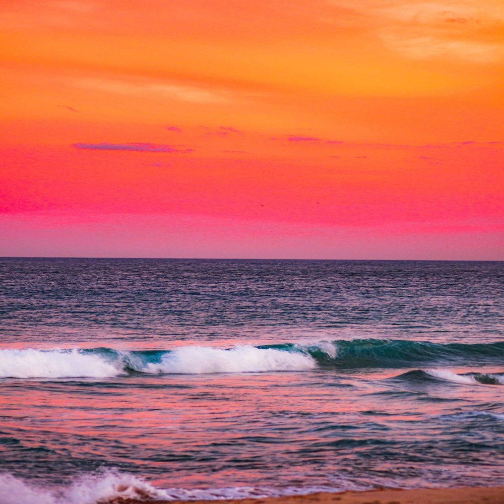Iconic Arts Breathtaking Orange Sky Over Breaking Wave Laminated Poster 24x36
