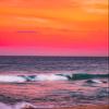 Iconic Arts Breathtaking Orange Sky Over Breaking Wave Laminated Poster 24x36 view 1