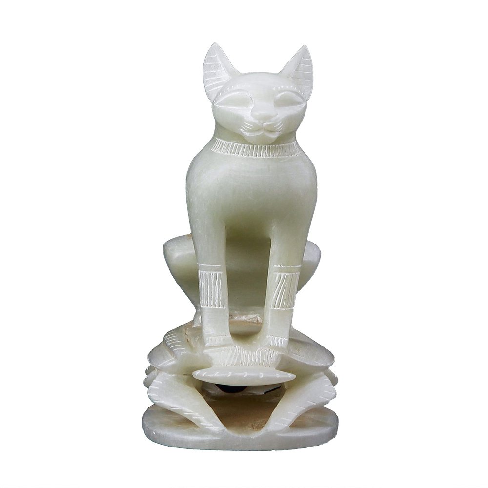 Ancient Egyptian statue of goddess Bastet cat standing on a Scarab hand carved Soap stone made in Egypt. Bastet in her late form of a cat-headed woman, rather than a lioness.