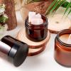 2oz Jars with Lids, Hoa Kinh 24 Pack Amber Glass Jars with Lids Empty Cosmetic Containers Round Airtight Glass Jar with Inner Liners and black Lid for Storing Lotions, Powders, and Ointments view 2