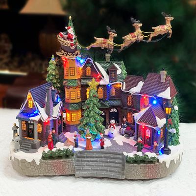 MOMENTS IN TIME Christmas Village Centerpiece Decor Santa Riding Sleigh Flying Over The Town Center Featuring LED Lights and Animation Power Adapter (Included)