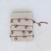 72" L Metal Bell Garland on Red Cord, Antique Gold Finish view 2