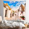 CORFOTO 117x78 Inch Italy Town Street Tapestry Famous Trulli Houses Sunny Blue Sky Italian Street Wall Background for Europe Themed Party Decor Wedding Bedroom Living Room Dorm Wall Hanging view 3