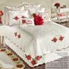 Poinsettia Holiday Floral Matelasse Bedding | Red and Ivory Velvet Flower Appliques | 11-Pc Bed Set: Oversized King Coverlet, Bedskirt, 2 King Shams, 2 Euro Shams, 2 Euro Inserts, & 3 Accent Pillows view 2